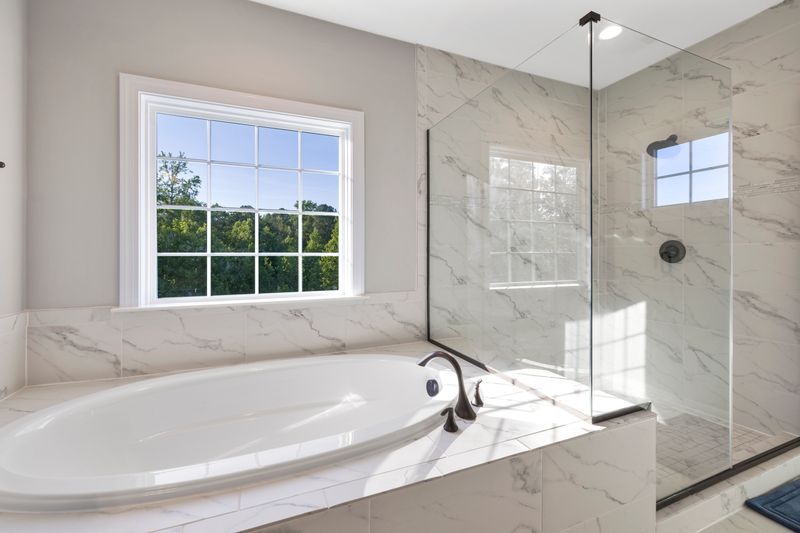 Elegant marble soaking tub bathed in natural light