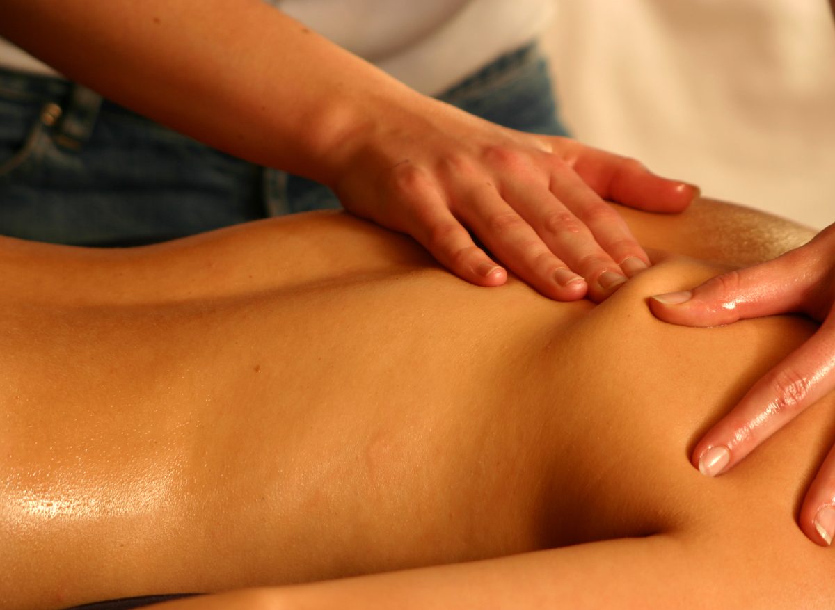 Therapist giving a relaxing oil back massage