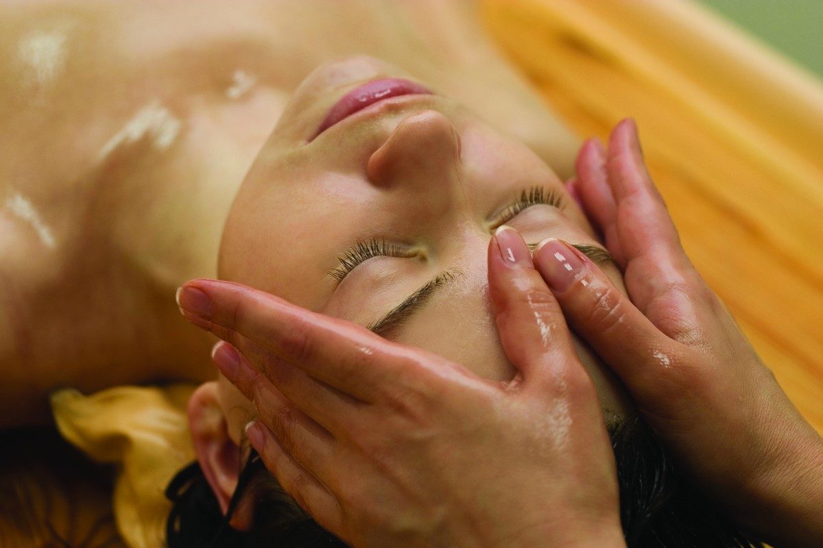 Therapist giving a gentle facial massage