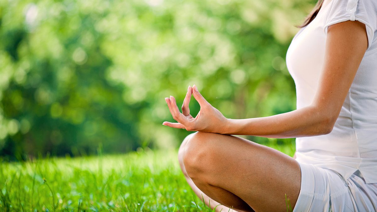 Guest practicing yoga in a peaceful outdoor setting