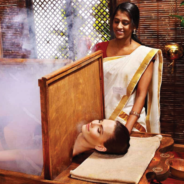 Guest receiving a traditional Swedana steam therapy